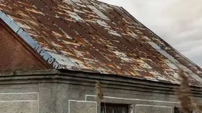 Sun-damaged roof with curled shingles