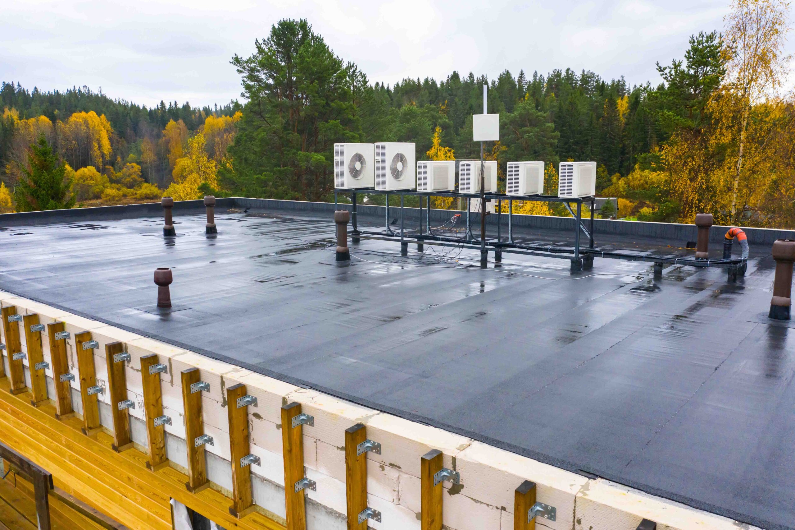 Commercial roof with blacktop and vents.